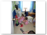 Kelly and Isabelle enjoy some playtime in Duncan's room, while parrents enjoy a peaceful moment.